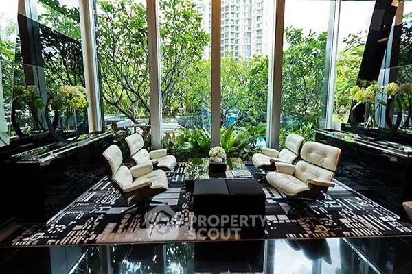 Luxurious living room with modern furniture and stunning garden view.