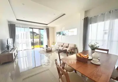 Spacious living room with modern decor and large windows offering natural light.