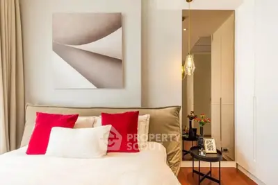 Elegant bedroom with modern decor and stylish lighting in a luxury apartment.