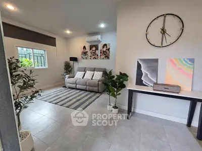 Modern living room with stylish decor, featuring a cozy sofa, wall art, and indoor plants for a welcoming ambiance.