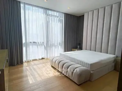 Luxurious bedroom with elegant design and floor-to-ceiling windows for natural light.