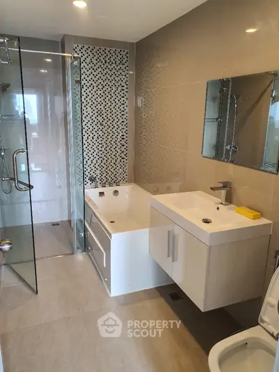 Modern bathroom with glass shower and stylish bathtub