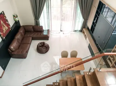 Spacious modern living room with large windows and elegant furniture