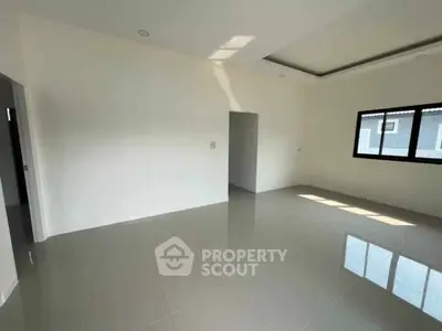 Spacious empty room with glossy tiled floor and large window