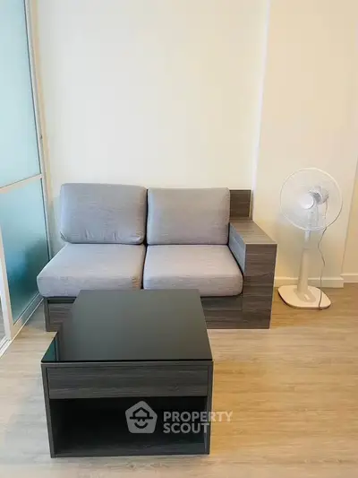 Modern living room with sleek sofa and stylish coffee table, perfect for urban living.