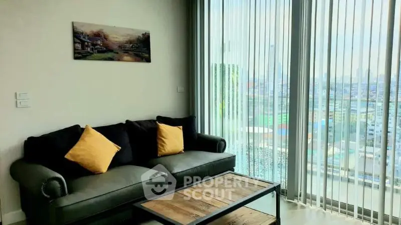 Modern living room with large windows offering stunning city views and stylish decor.
