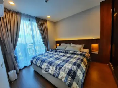 Luxurious bedroom with elegant decor and large window offering natural light.