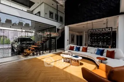 Luxurious modern living room with elegant staircase and stylish decor