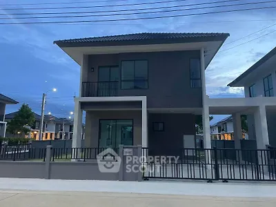 Modern two-story house with sleek design and spacious driveway in a serene neighborhood.