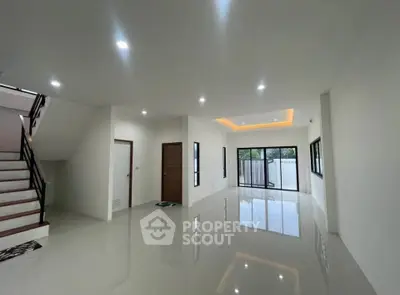 Spacious modern living room with glossy floors and large windows