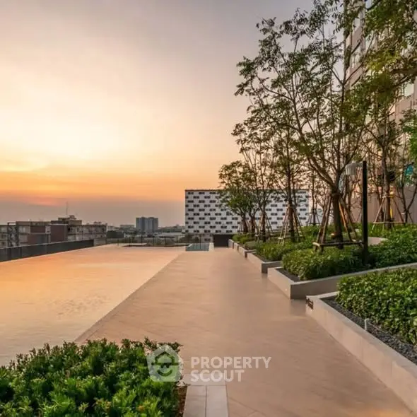 Stunning rooftop garden with sunset view in modern urban setting.