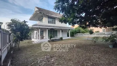 Charming two-story house with spacious garden and lush greenery