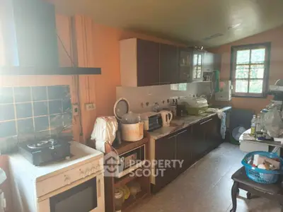 Cozy kitchen with gas stove and ample storage in a warm, inviting home.