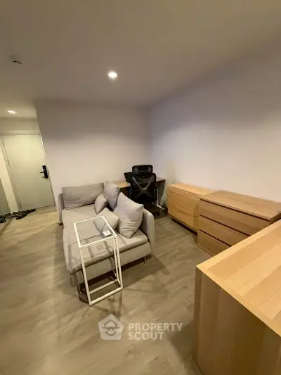 Modern living room with sleek furniture and wooden flooring, perfect for urban living.