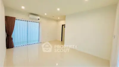 Spacious unfurnished living room with bright lighting and large window