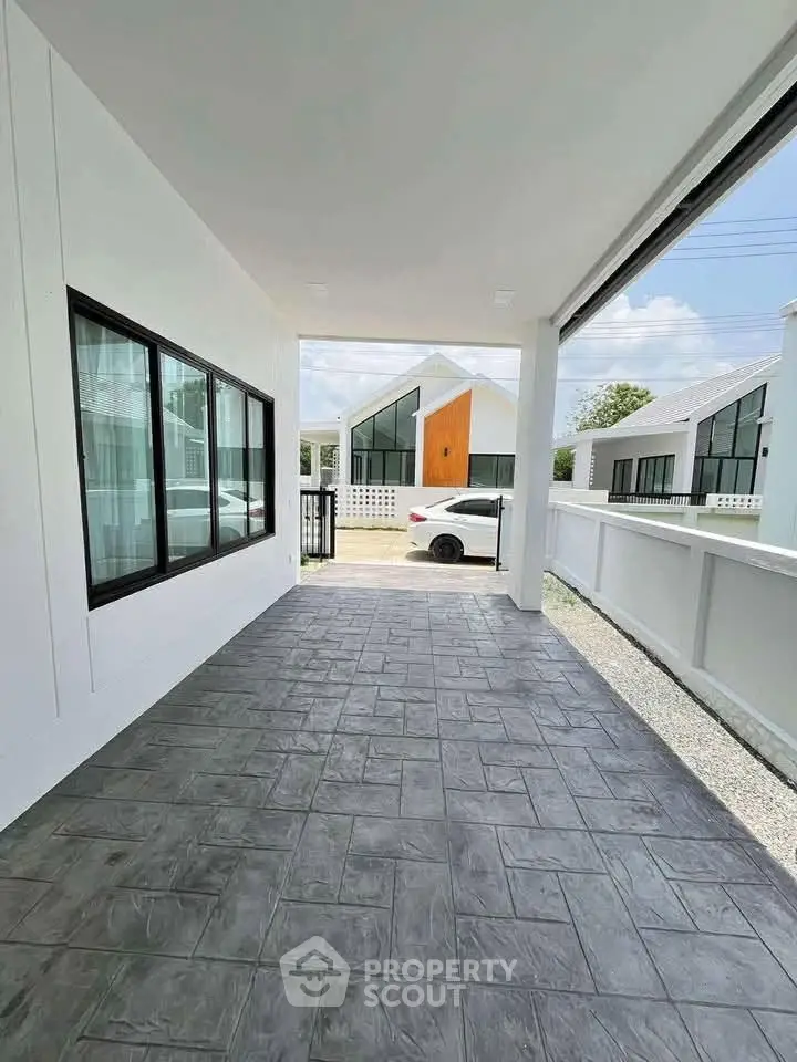 Modern residential property with spacious driveway and contemporary architecture.