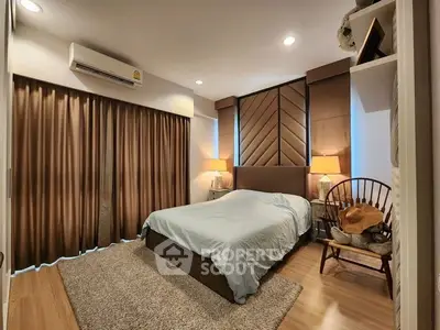 Luxurious bedroom with elegant decor and cozy lighting, featuring a plush bed and stylish furnishings.