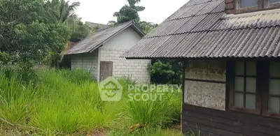 Charming rustic property with lush greenery and traditional architecture.