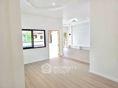 Spacious modern living room with large windows and elegant flooring