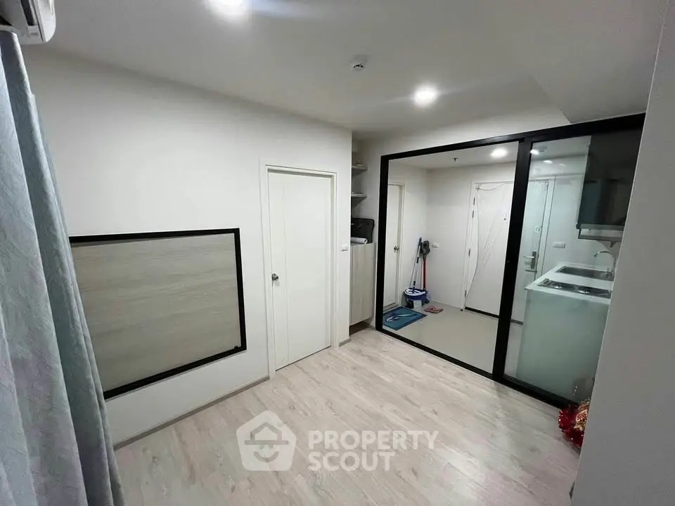 Modern apartment interior with sleek kitchen and spacious living area, perfect for urban living.