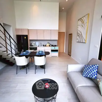 Modern open-plan living room with stylish kitchen and elegant decor