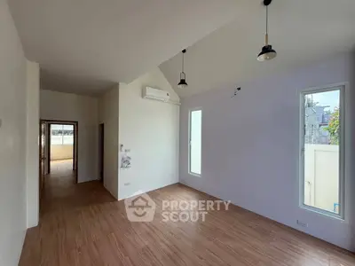 Spacious modern living room with high ceiling and wooden flooring