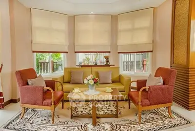 Elegant living room with cozy seating and large windows, perfect for relaxation and entertaining.