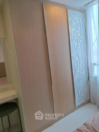 Modern bedroom with stylish wardrobe and natural light