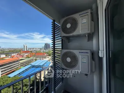 Stunning city view from a high-rise balcony with air conditioning units, perfect for urban living.