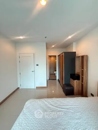 Spacious bedroom with modern furnishings and elegant decor