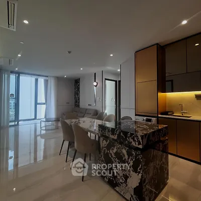 Luxurious open-plan living room with modern kitchen and marble island in high-rise apartment.