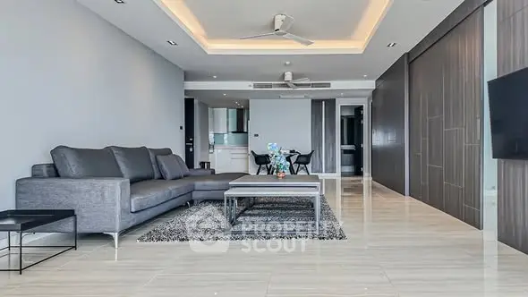 Spacious modern living room with sleek design and elegant furnishings.