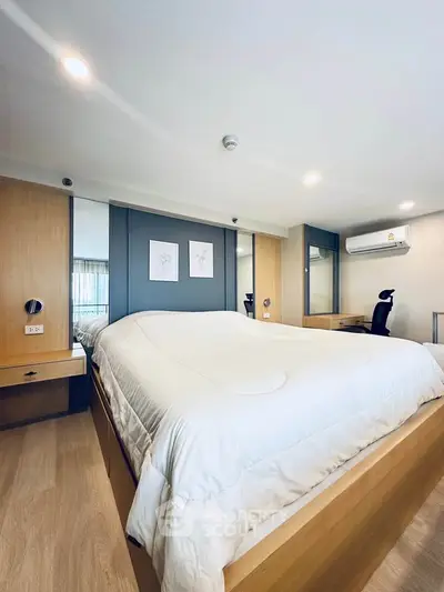 Spacious modern bedroom with stylish decor and natural light