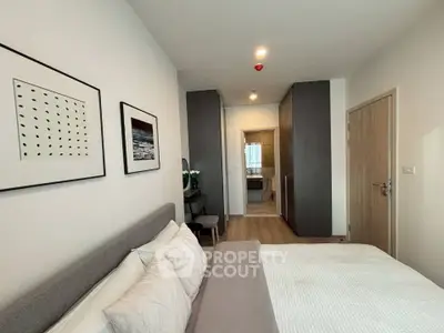 Modern bedroom with stylish decor and ensuite bathroom in a contemporary apartment.