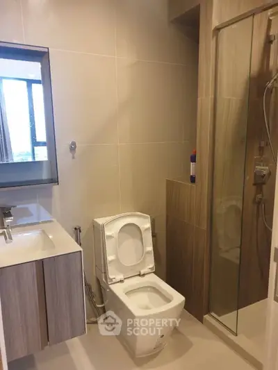 Modern bathroom with sleek fixtures and glass shower enclosure
