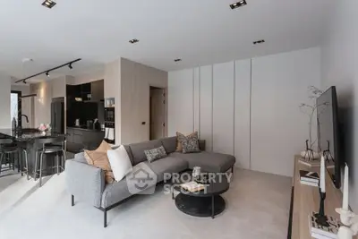 Modern open-plan living room with sleek kitchen and stylish decor