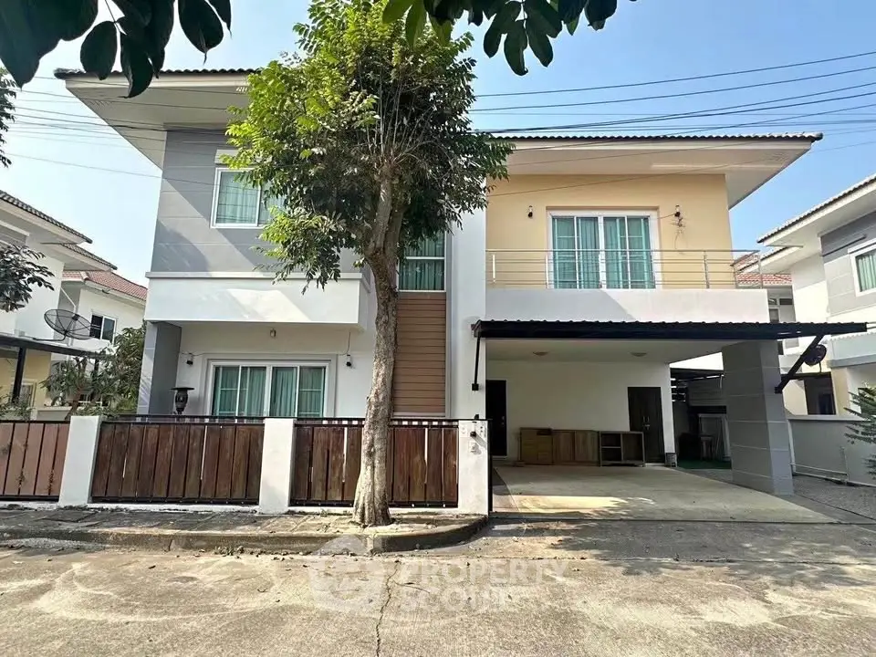 Modern two-story house with spacious driveway and balcony in suburban neighborhood.