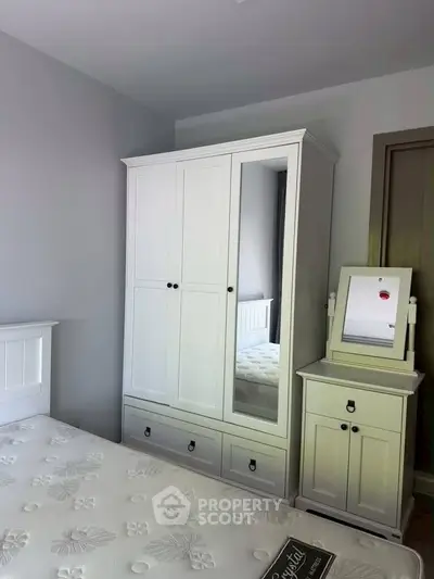 Charming bedroom with elegant white furniture and cozy ambiance, perfect for relaxation and comfort.