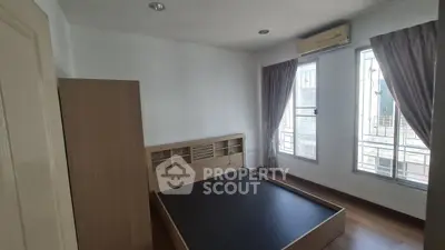 Spacious bedroom with large windows and air conditioning in modern apartment