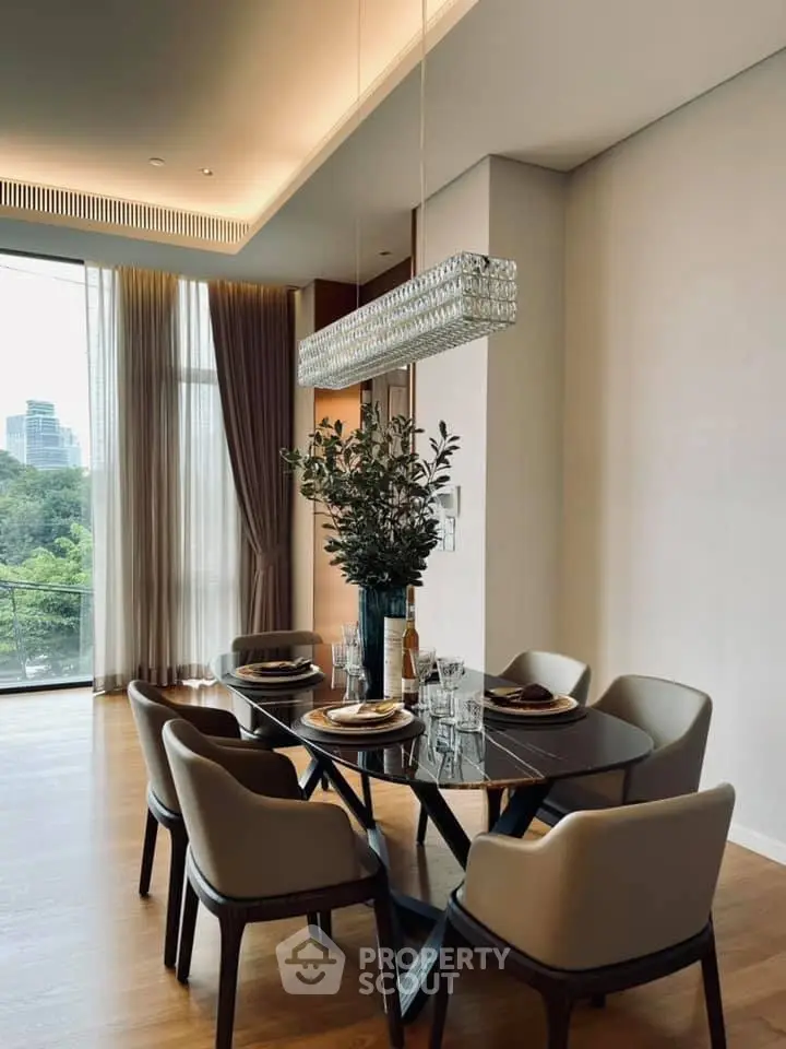 Elegant dining area with modern furniture and large windows offering a scenic view, perfect for sophisticated living.