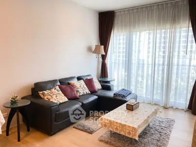 Stylish living room with leather sofa and large window offering natural light