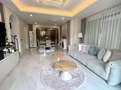 Spacious modern living room with elegant decor and open dining area