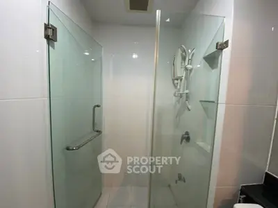 Modern bathroom with glass shower enclosure and sleek fixtures