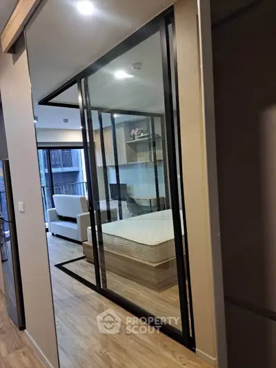 Modern apartment interior with glass partition and wooden flooring