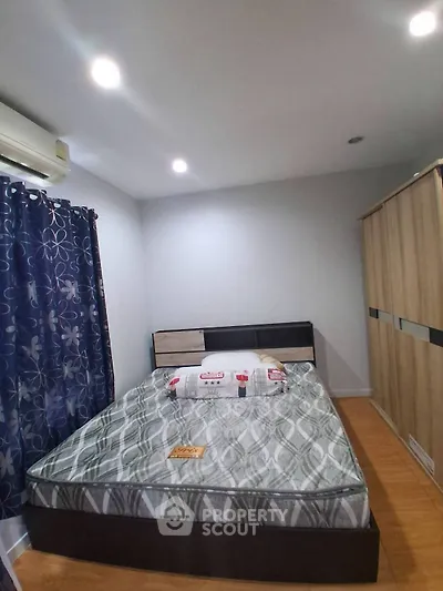 Cozy bedroom with modern decor, featuring a comfortable bed and stylish wardrobe.