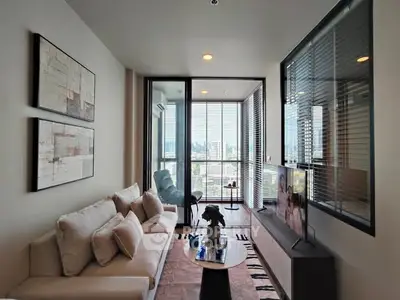 Modern living room with city view, stylish decor, and cozy seating area.