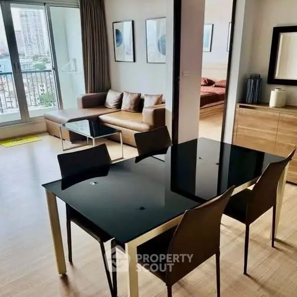 Modern open-plan living and dining area with sleek furniture and city view balcony.