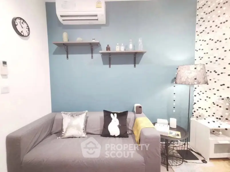 Cozy living room with modern decor and stylish shelving, perfect for relaxation.