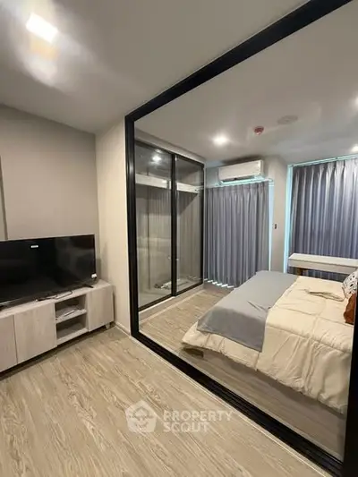 Modern bedroom with glass partition and sleek decor