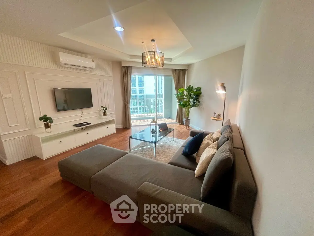 Modern living room with stylish decor and large window view in a high-rise apartment.